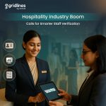 Two hospitality professionals using a tablet for digital staff verification at a hotel front desk.